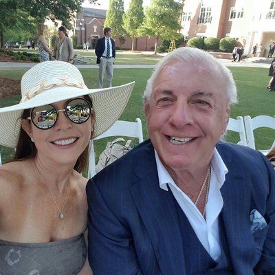 Wendy Barlow is wearing a hat and a grey dress while Ric Flair is wearing a suit in this pic.